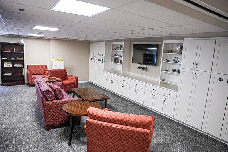 A cozy living room with comfortable seating, a television, and built-in shelves.