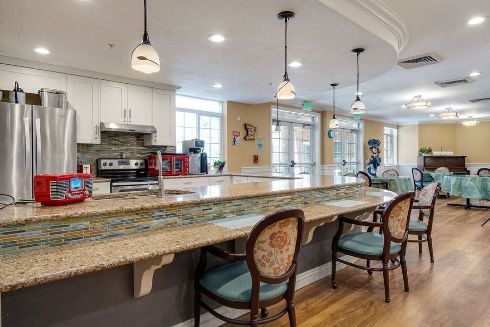 A modern kitchen interior with a spacious countertop and elegant bar stools.