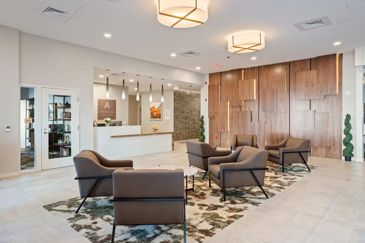 Modern lobby with comfortable seating and a reception desk.