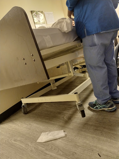 A healthcare professional attending to a patient in a hospital setting.