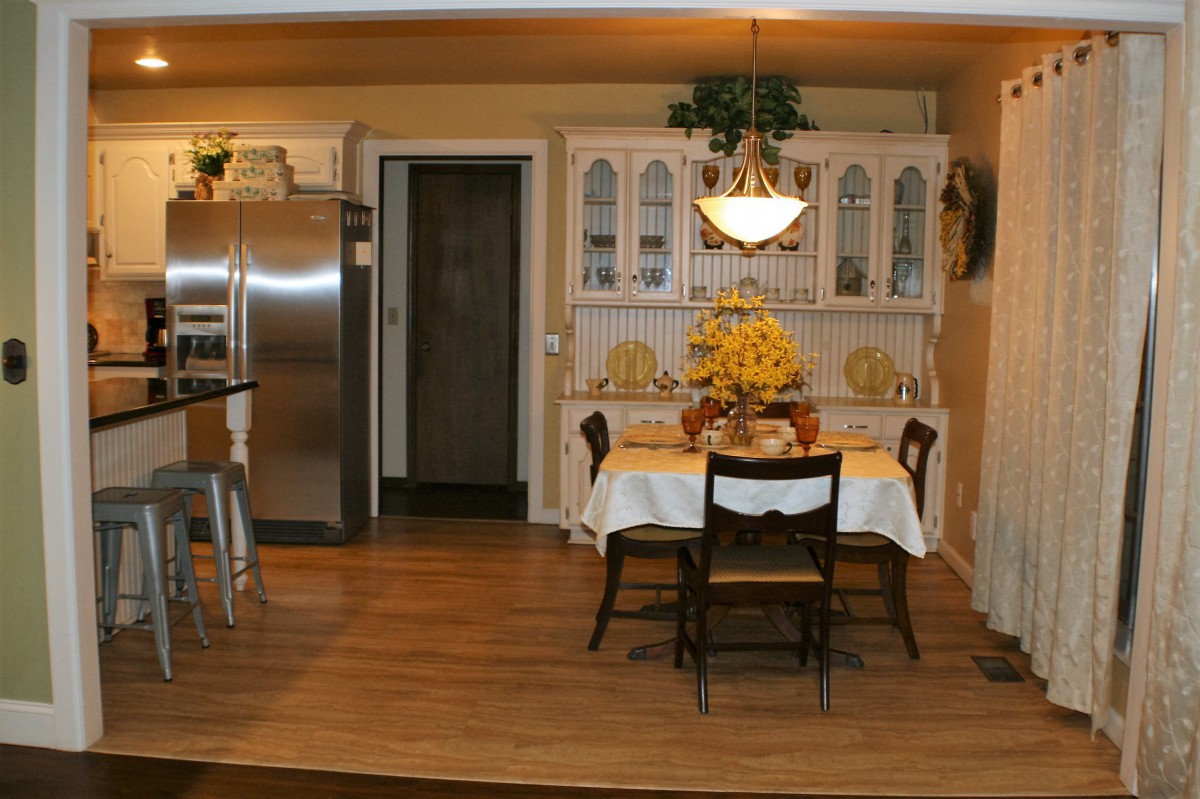 A cozy dining area with a classic table and chairs, adjacent to the kitchen.