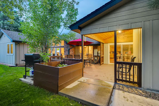 A cozy backyard patio with warm evening lights, perfect for relaxation and outdoor gatherings.