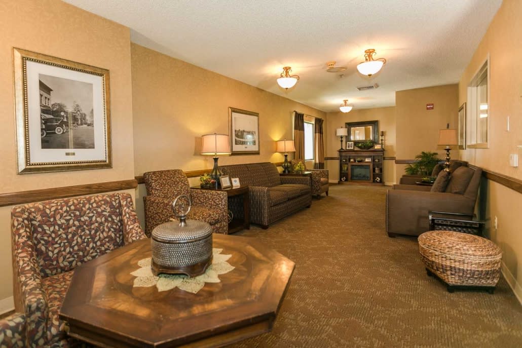 A cozy living room with sofas, a coffee table, and warm lighting.