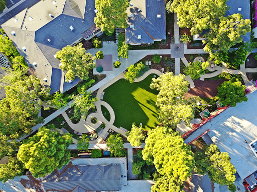 A beautiful aerial view of a landscaped neighborhood featuring winding paths and lush greenery.