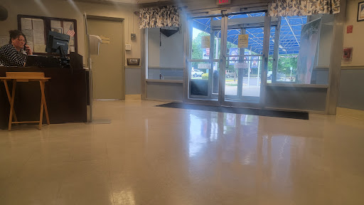 A bright and clean lobby area with large windows allowing natural light in.