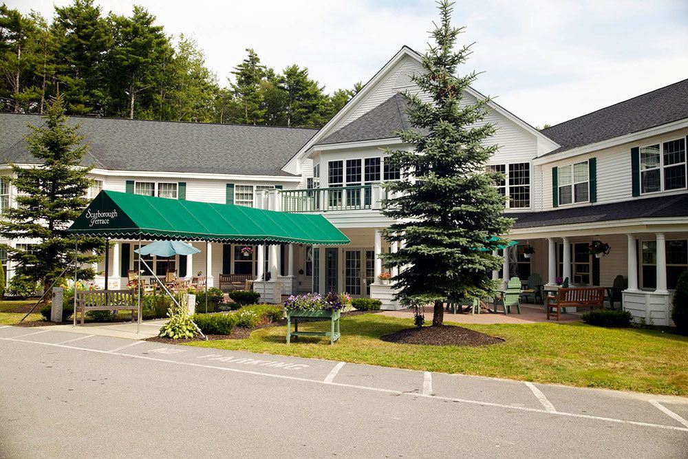 A charming residential building with a well-maintained garden and driveway.