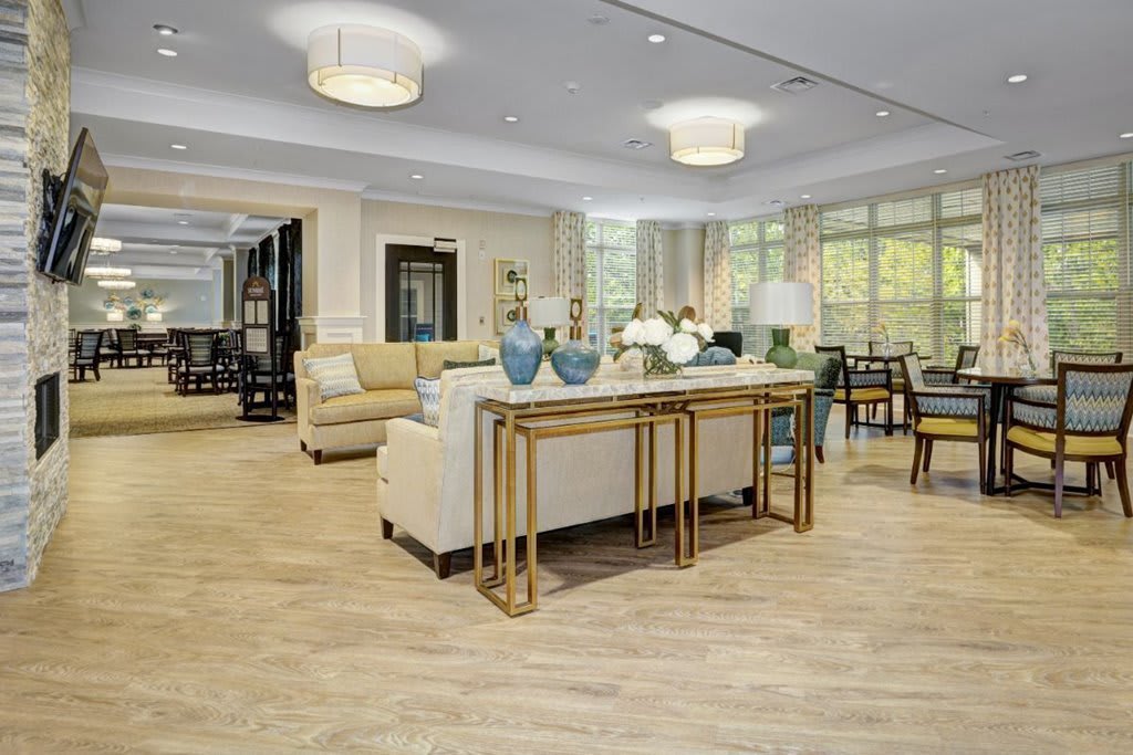 A spacious and elegantly designed living room with modern furniture and abundant natural light.