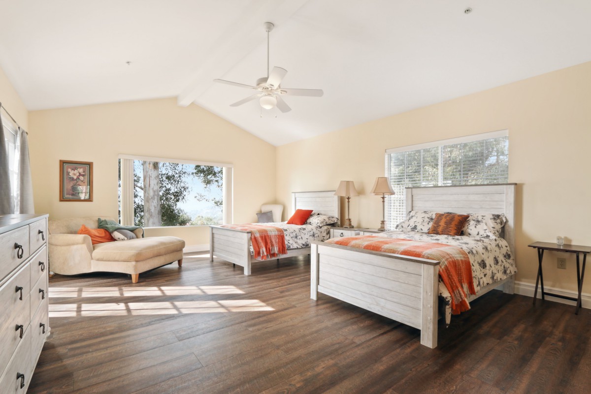 Spacious bedroom with elegant furniture and natural light.