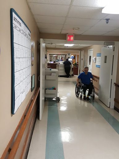 A patient navigating a hospital corridor in a wheelchair.