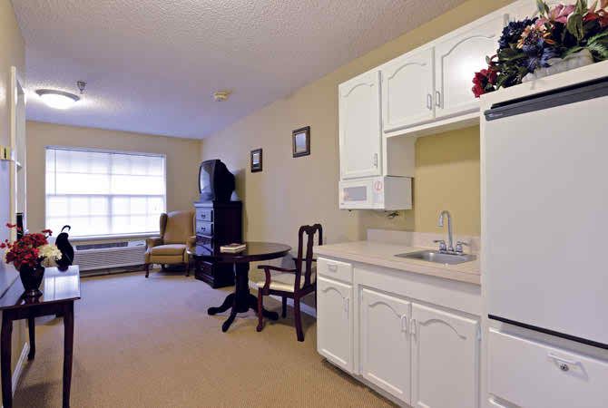 Cozy apartment with a kitchenette and seating area.
