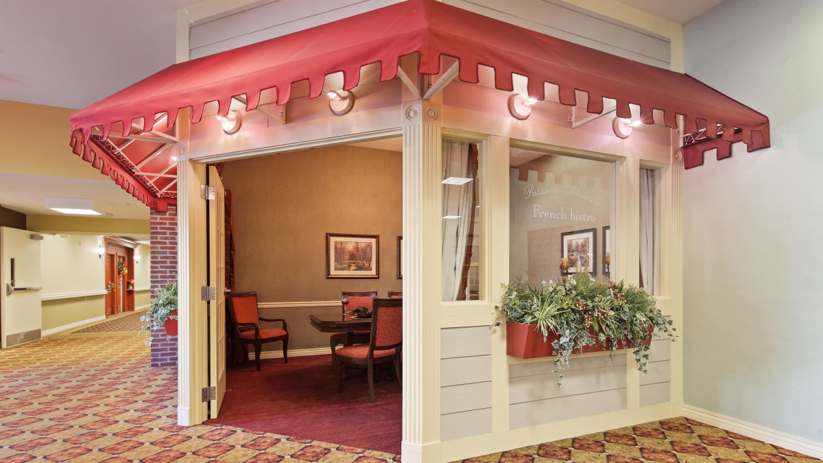 A cozy room with decorative walls and potted plants, styled to resemble an outdoor facade.
