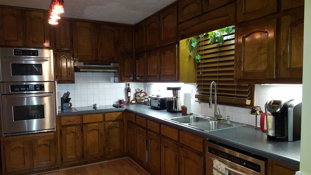 A cozy kitchen with wooden cabinets and modern appliances.
