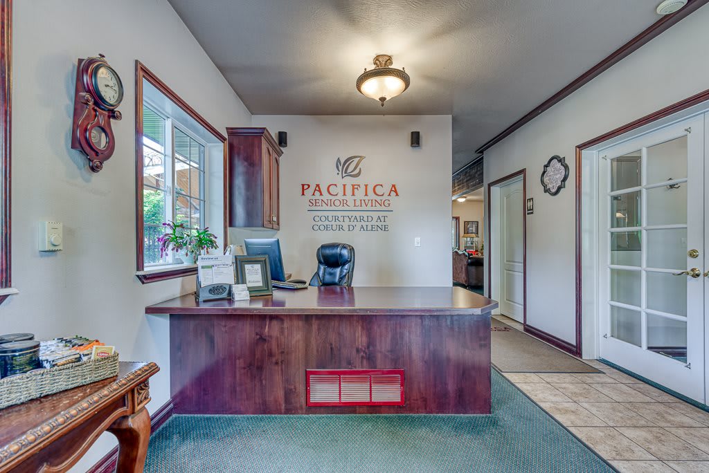 Reception area with a desk and office decor.
