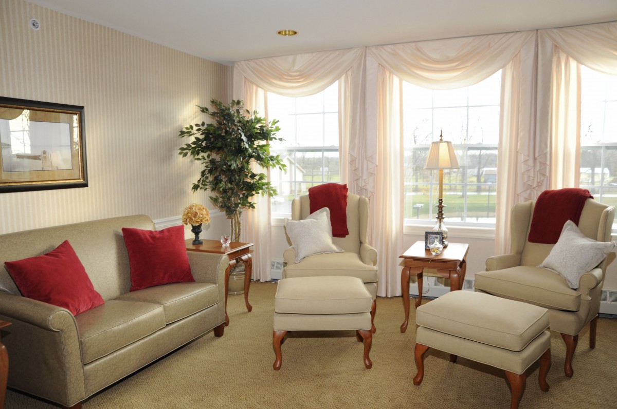 A cozy living room with elegant furniture and large windows.