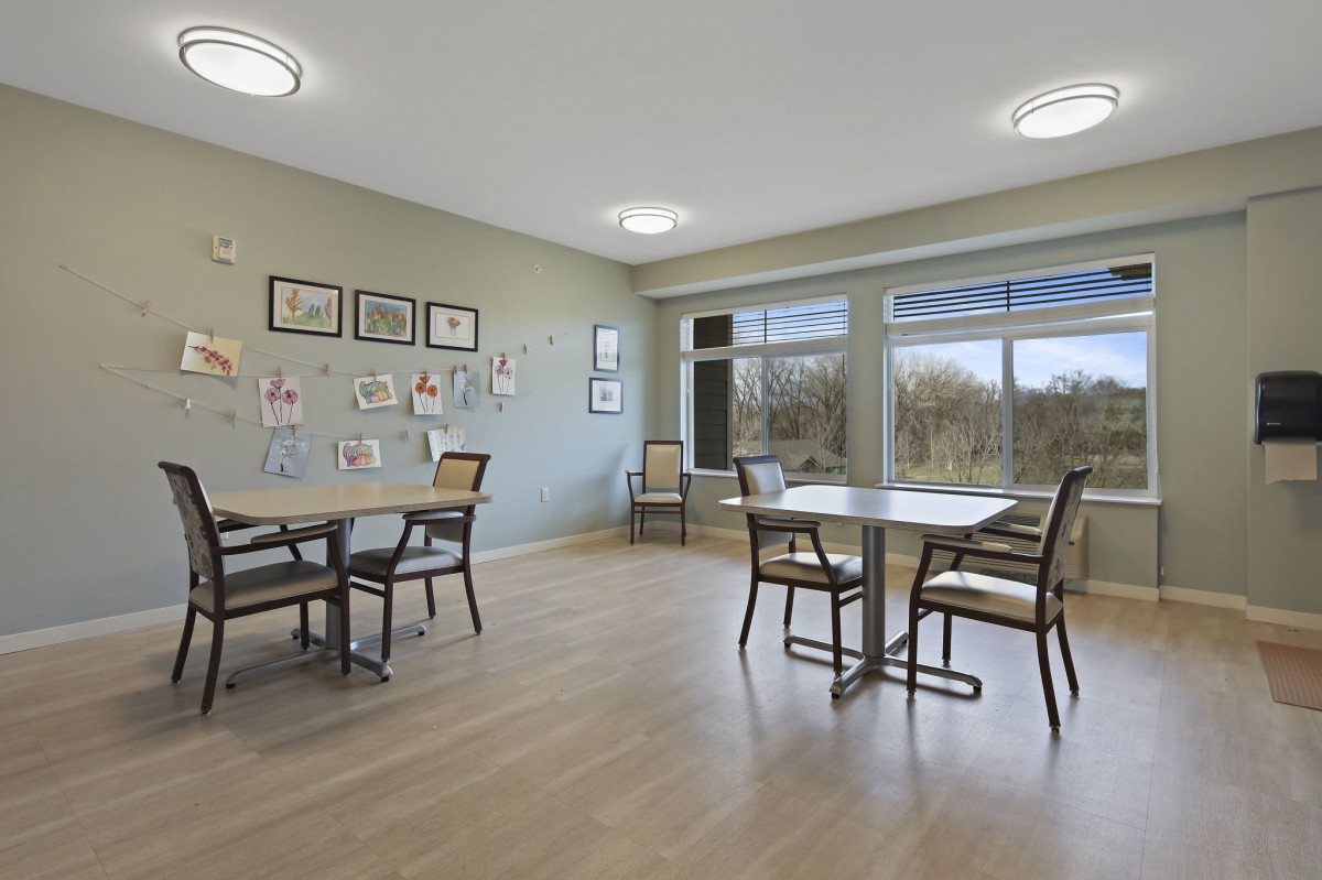 A modern dining area with large windows and minimalist decor.