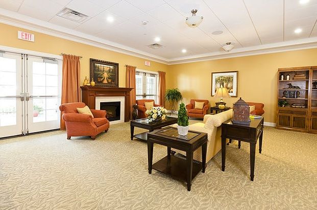 A cozy living room with a fireplace, comfortable sofas, and elegant decor.
