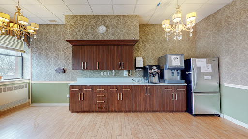 A modern kitchen setup featuring wooden cabinetry and contemporary appliances.