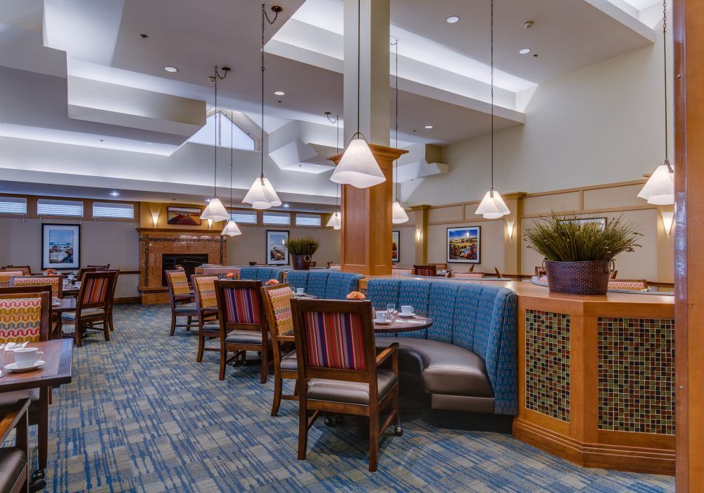 A stylish and well-lit dining area with comfortable seating and elegant decor.