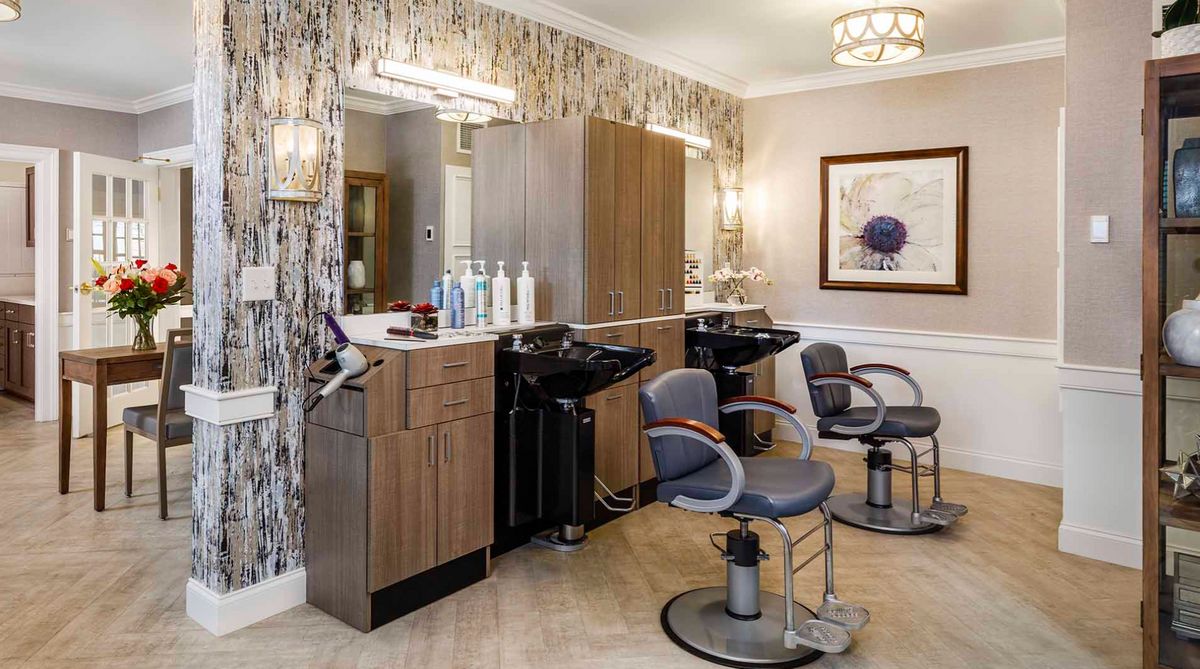 A modern hair salon interior with styling chairs and mirrors.