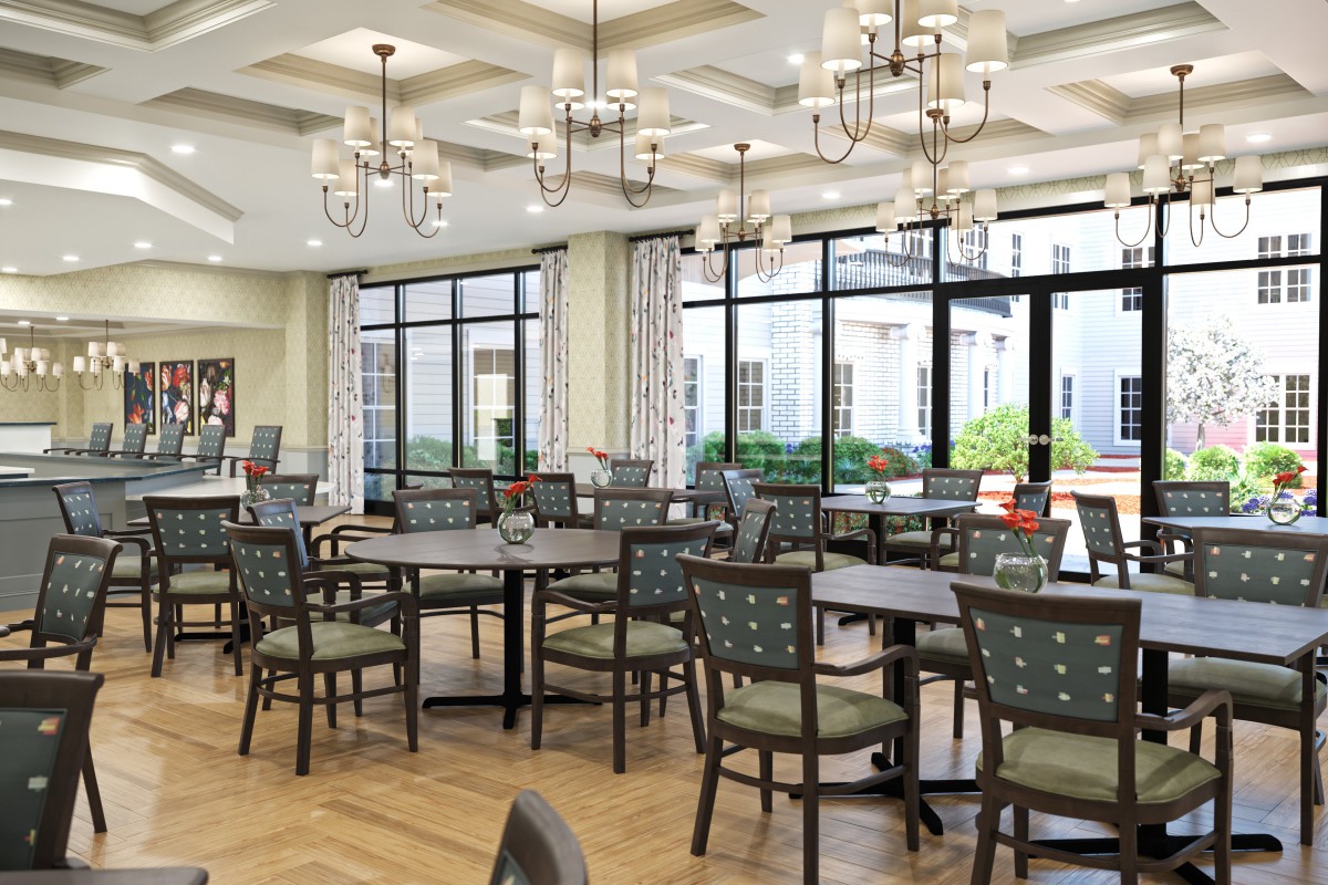 A spacious dining room with elegant chandeliers and large windows.