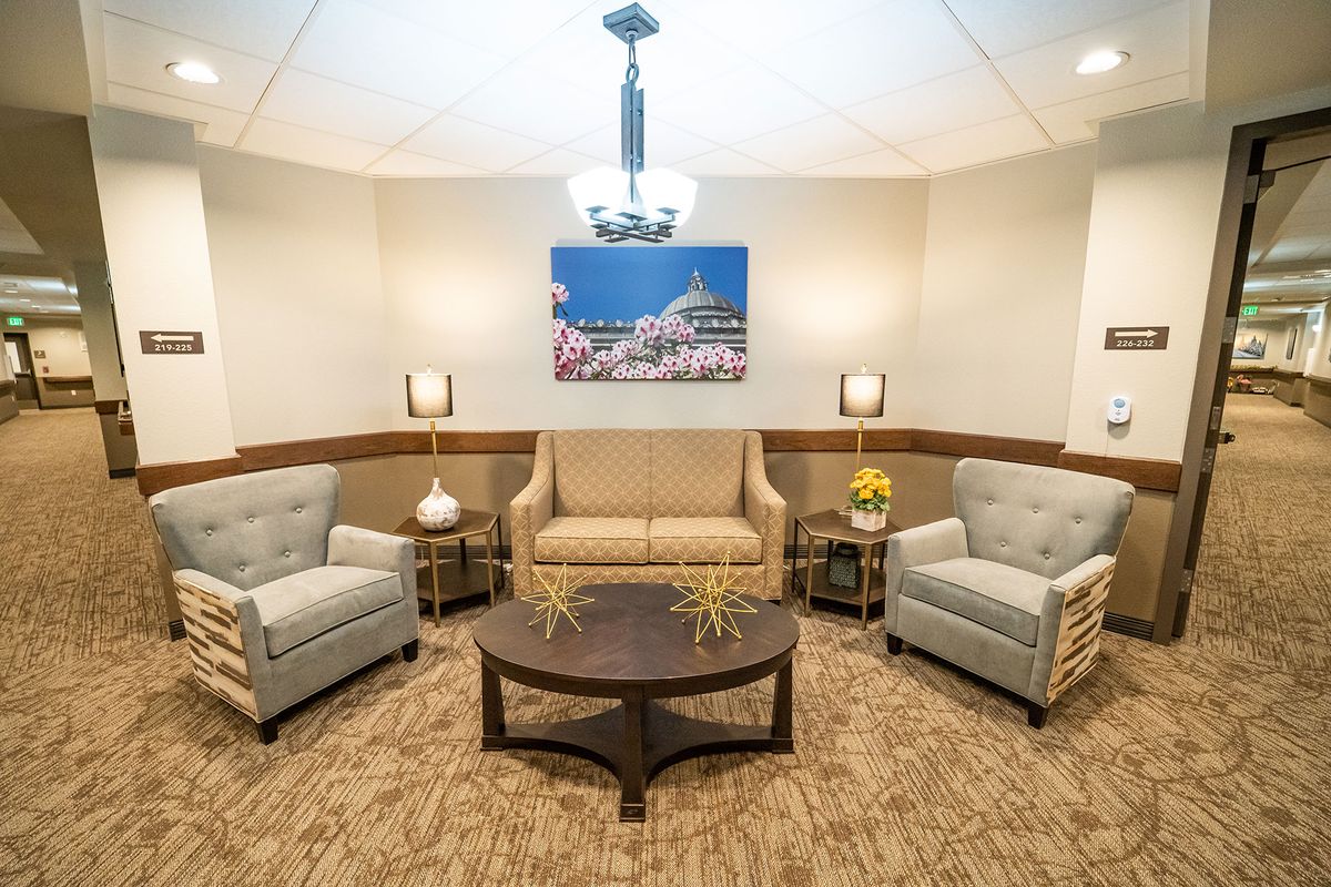 A cozy waiting room with comfortable seating and soft lighting.