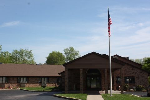 A building with an American flag outside under a clear blue sky.