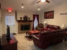 A cozy living room with a fireplace and comfortable seating.