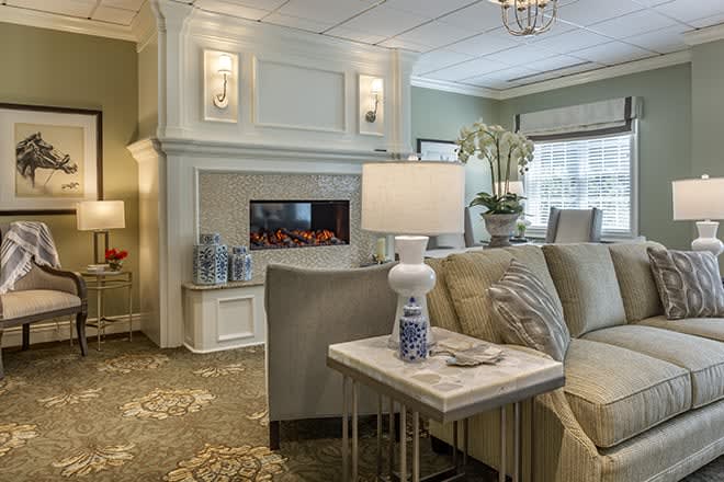 A cozy and modern living room featuring a fireplace, elegant lighting, and comfortable seating.