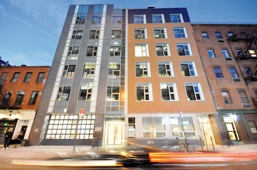 A modern building showcasing a mix of architectural styles in an urban setting.
