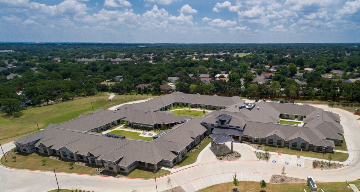 Aerial view of a large residential building complex in a suburban area.