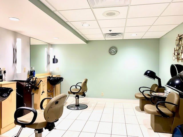 An empty salon with styling chairs and equipment.