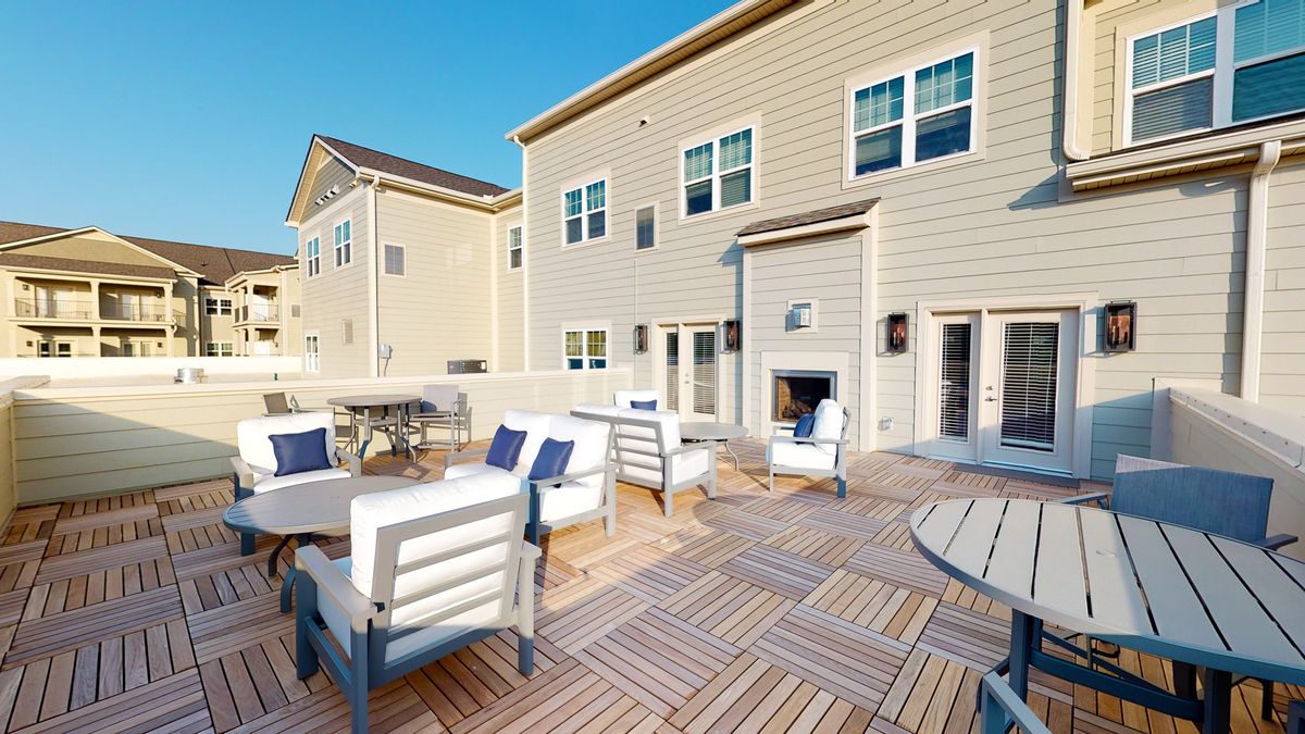Spacious outdoor patio with modern furniture and stylish decking.