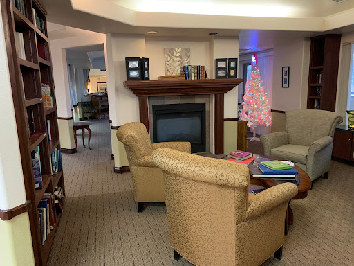 A cozy living room featuring comfortable seating, a fireplace, and decorative elements.