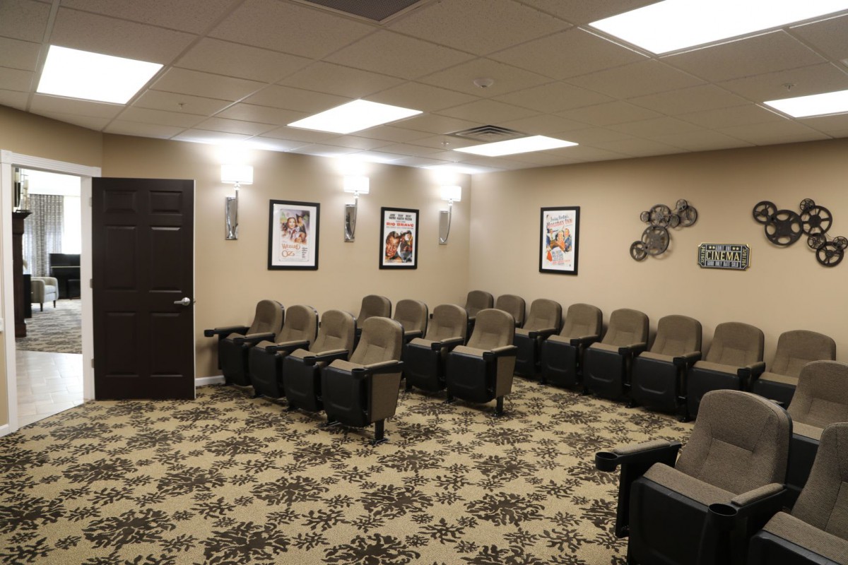 A cozy home theater room with comfortable seating and wall decorations.
