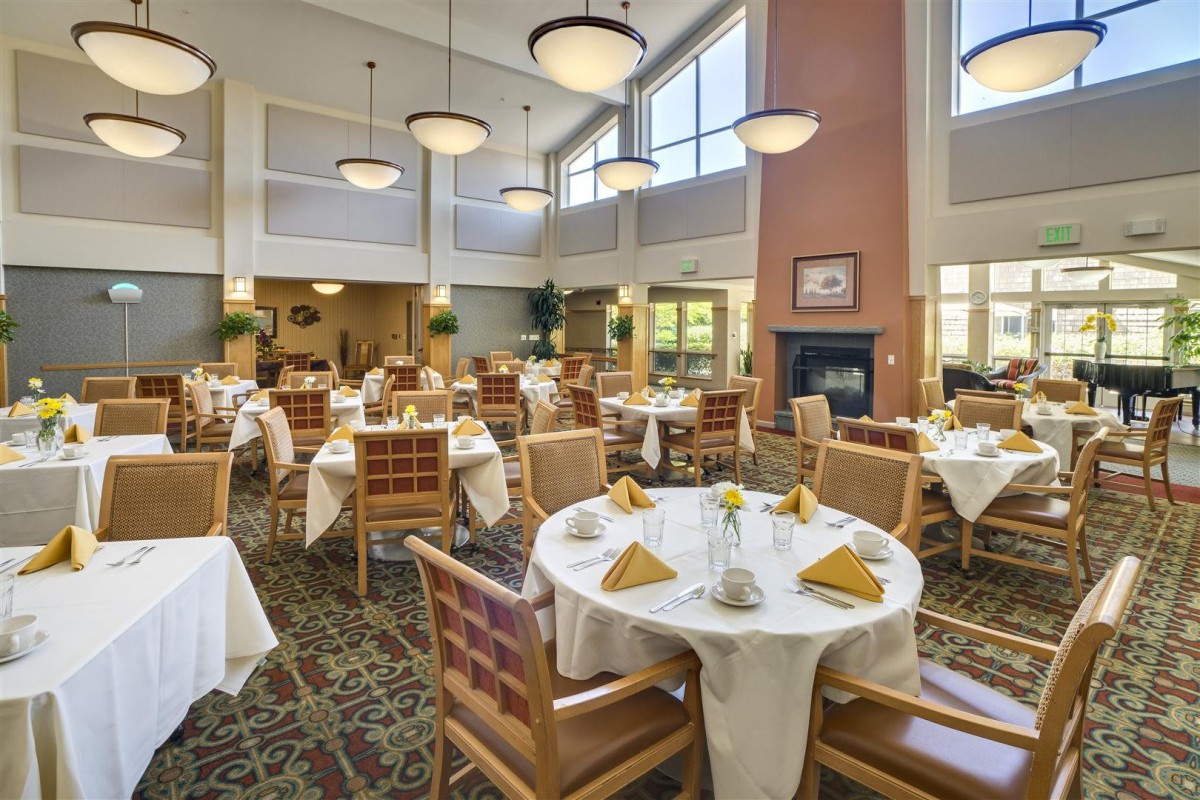 Elegant dining area with neatly arranged tables and warm lighting.