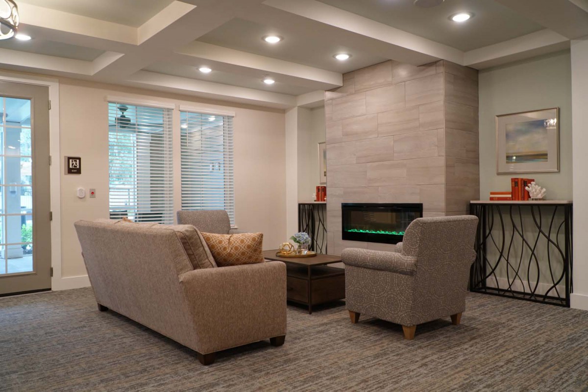 A modern living room with comfortable seating and a cozy fireplace.
