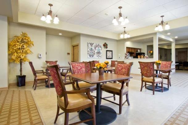 A well-lit dining area with neatly arranged tables and chairs, adorned with decorative elements.