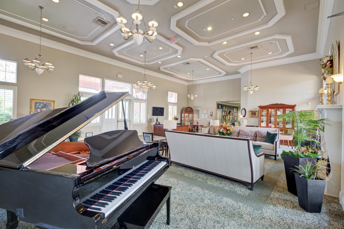 A luxurious living room featuring a grand piano and elegant furnishings.