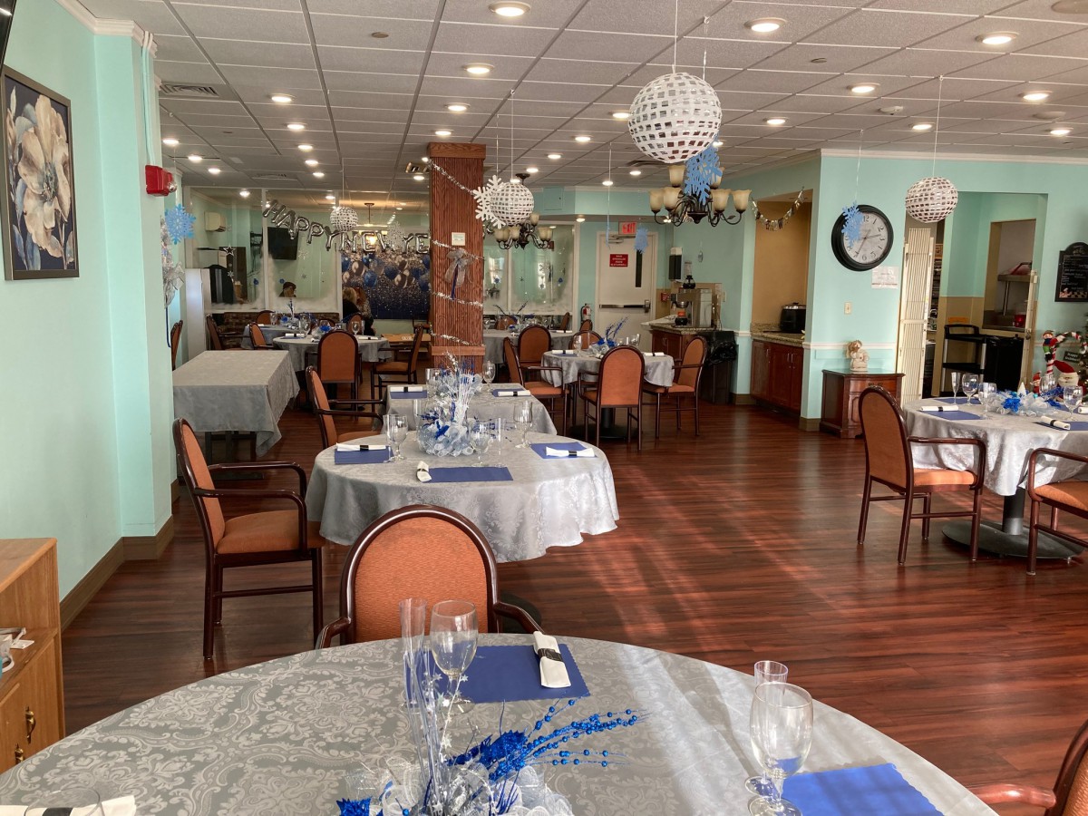 A well-decorated dining area in a restaurant with neatly arranged tables and chairs.