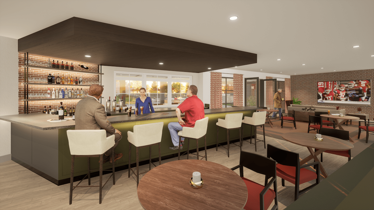 A modern bar interior with patrons seated at the counter.