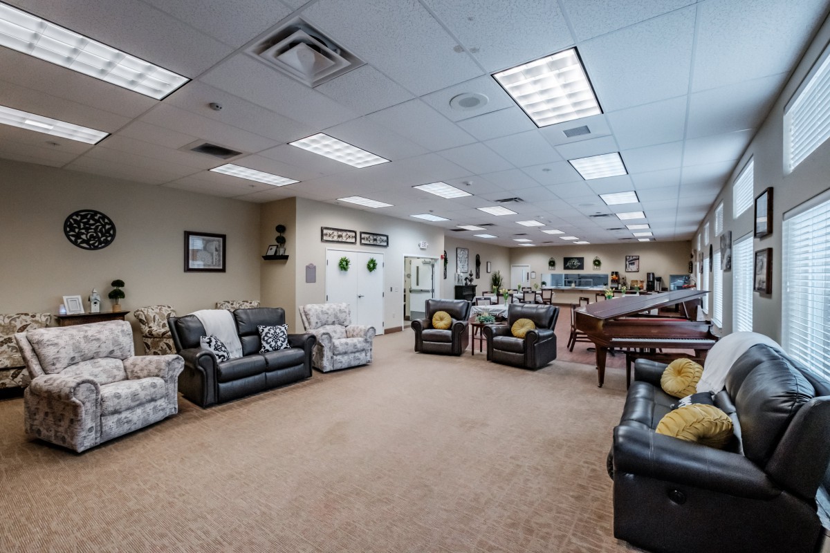 A spacious lounge area with comfortable seating and bright lighting.