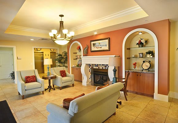 A cozy living room featuring a fireplace, comfortable seating, and elegant decor.
