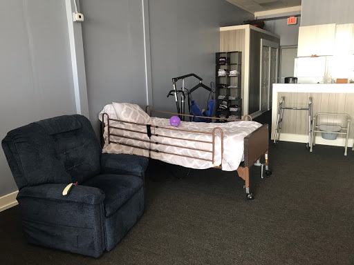 A hospital bed and a recliner chair in an interior space.