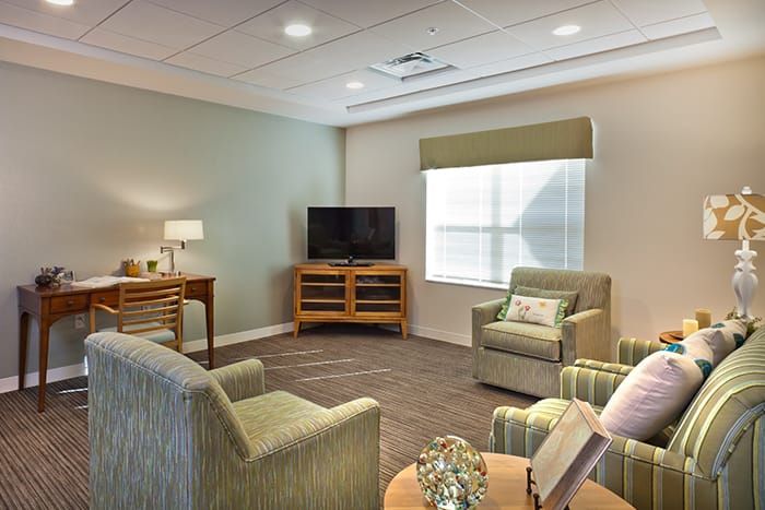 A cozy living room with modern furnishings and a television.