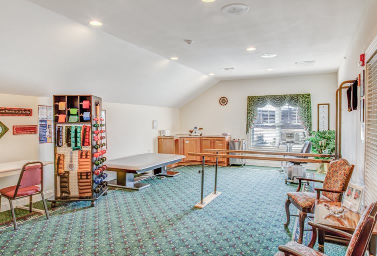 A spacious crafting room with organized shelves and a sewing area.