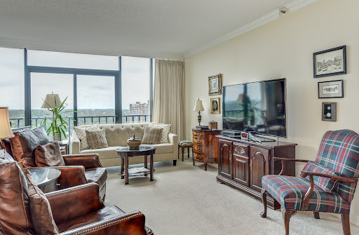 A cozy living room featuring modern furniture and a large window that provides natural light.