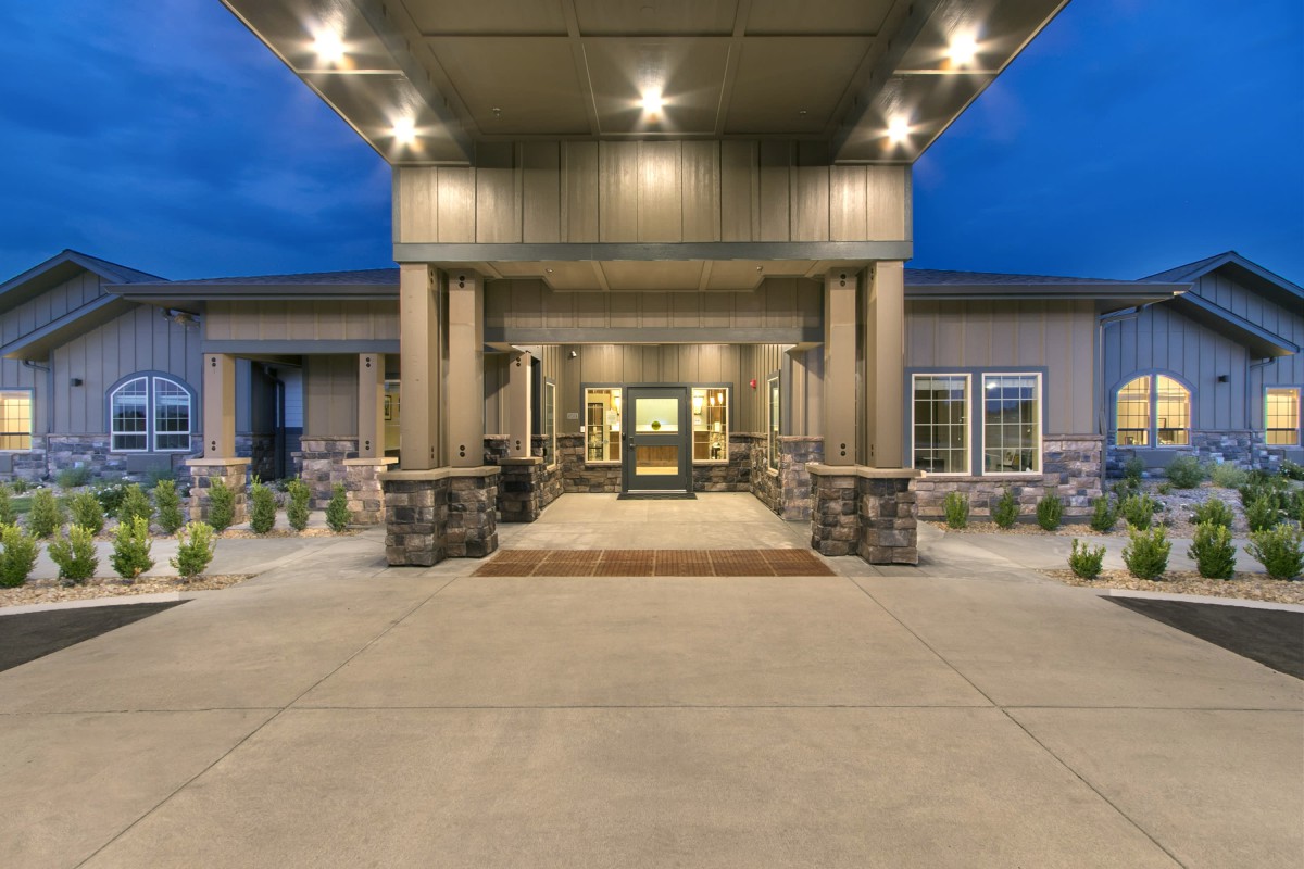 A well-lit building entrance in the evening.