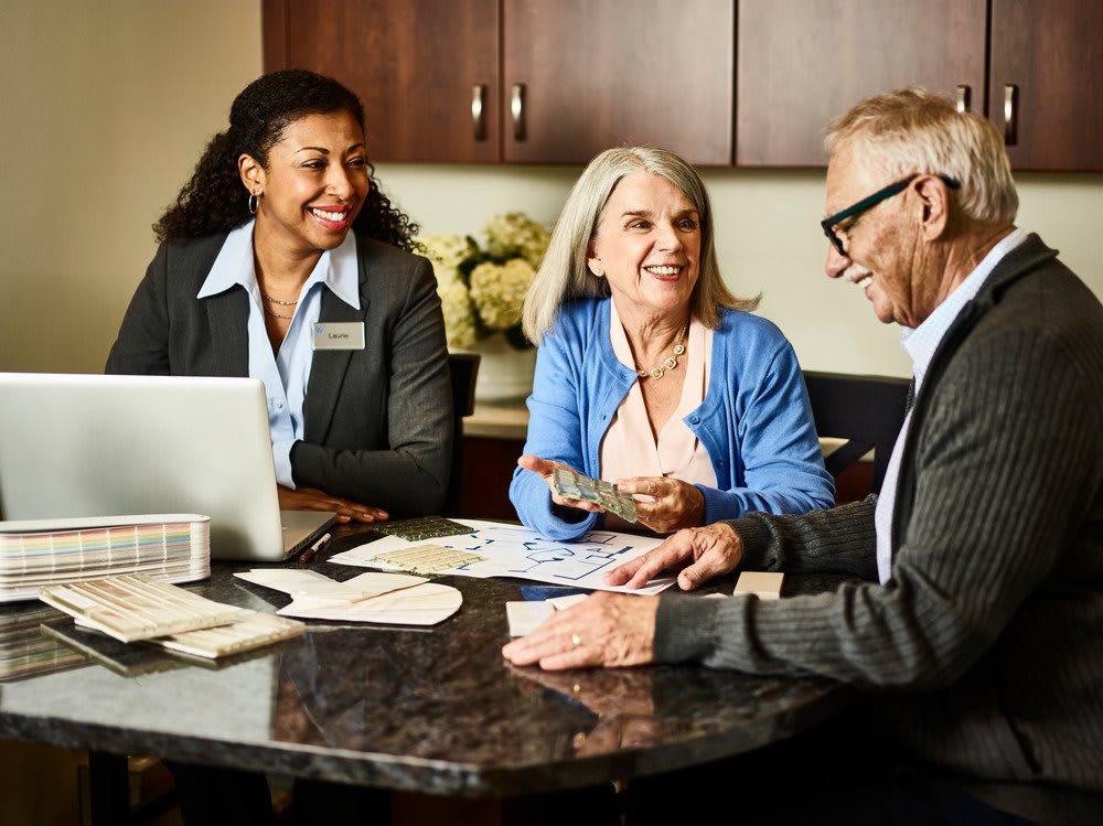 A group of people engaged in a business discussion around a table.