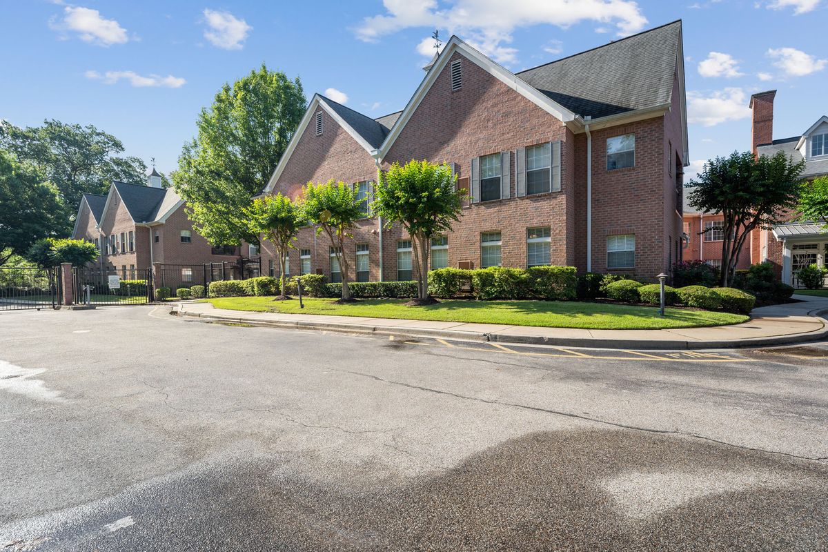 A suburban residential building with brick construction on a sunny day.