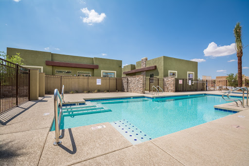 A serene outdoor swimming pool at a residential apartment complex, perfect for relaxation on a sunny day.